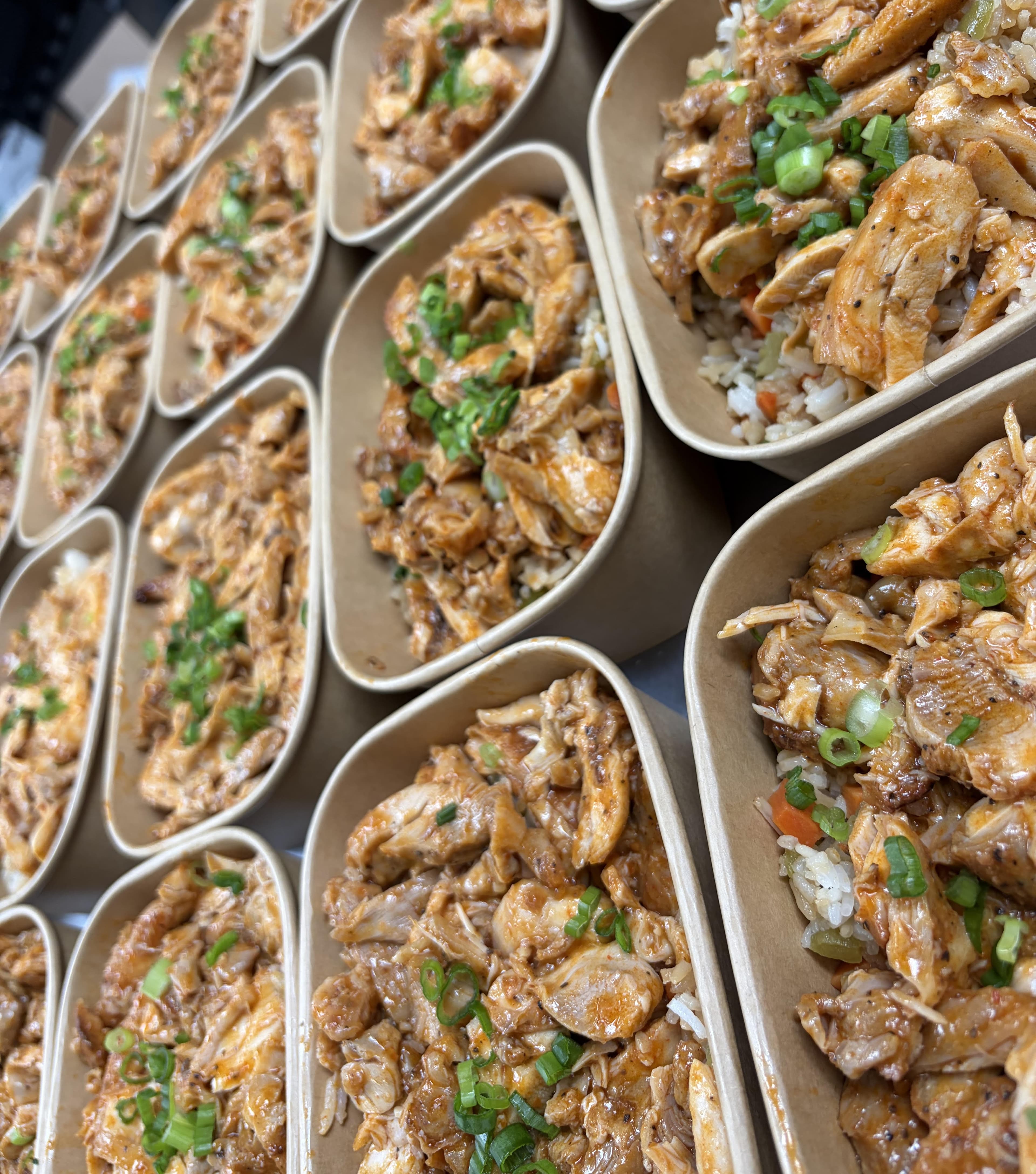 Trays of freshly packed meal-prep boxes from a 7eats cook
